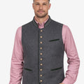 Male model wearing grey wool Alpine piping vest paired with traditional Bavarian outfit, suitable for Oktoberfest and cultural events.