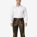 Front view of model wearing handmade Bavarian Bundhosen for men in dark brown leather with traditional embroidery and knee tie details
