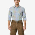 Model wearing handmade Bavarian lederhosen for men in brown leather with traditional embroidery and Oktoberfest belt buckle