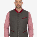 Front view of model wearing Heritage Style Trachten Vest Men in grey wool with red trim collar and metal buttons