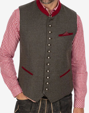 Model wearing heritage style trachten vest for men displaying fitted silhouette, button closure and authentic festival styling