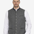 Model wearing grey German wool waistcoat with horn buttons, paired with traditional Bavarian outfit, ideal for Oktoberfest and Alpine wear.