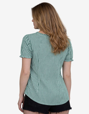 Woman wearing a green checkered shirt on a white background