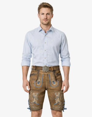 Man wearing a light blue shirt and brown embroidered shorts on a white background