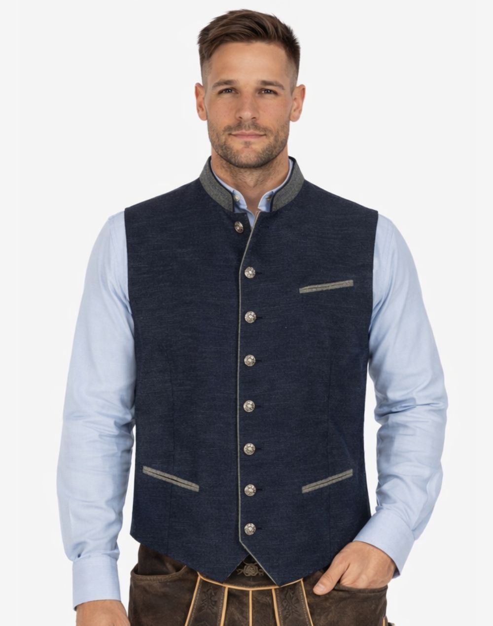 Front view of model wearing Luxury Bavarian Trachten Vest in navy fabric with decorative silver buttons and contrast trim