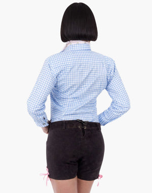 Back view of a woman wearing brown embroidered lederhosen shorts with pink lace ties and a blue gingham shirt in traditional Oktoberfest style.