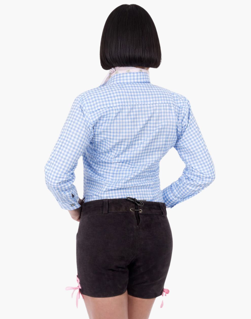 Back view of a woman wearing brown embroidered lederhosen shorts with pink lace ties and a blue gingham shirt in traditional Oktoberfest style.