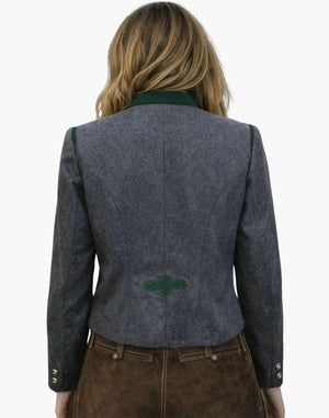 Person wearing a gray blazer with green accents on a white background