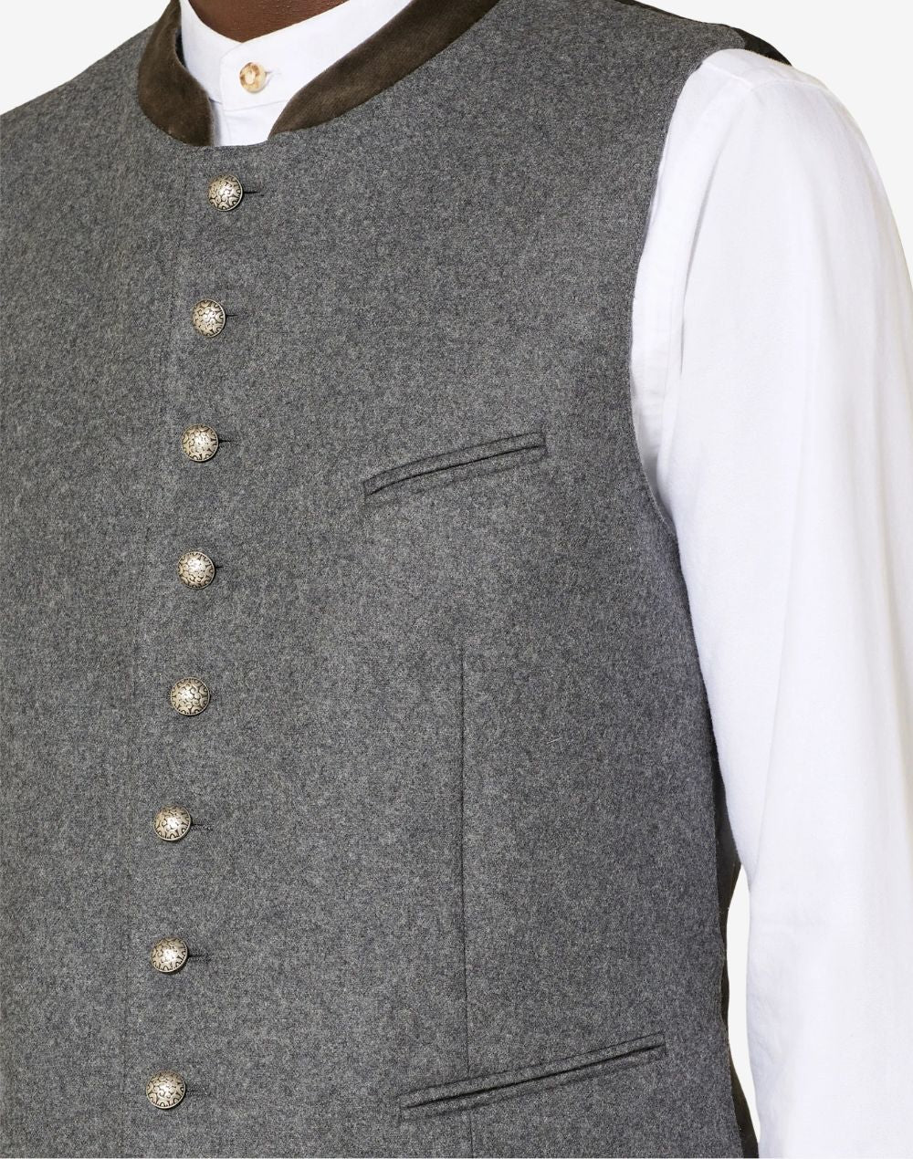 Close up of mens authentic Alpine vest showing decorative metal buttons, wool texture and classic Bavarian craftsmanship.