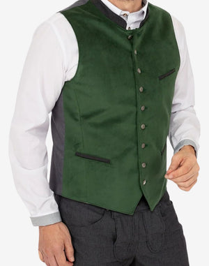 Model wearing authentic Bavarian trachten vest featuring green front panel, metal buttons and traditional Oktoberfest styling