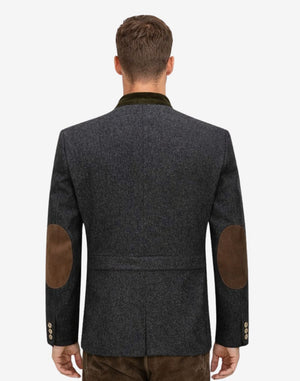 Back view of model wearing Mens Authentic German Jacket featuring elbow patches and tailored alpine silhouette