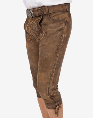 Side angle showing men’s bundhosen with long embroidered leg panel, curved pocket opening and aged leather finish