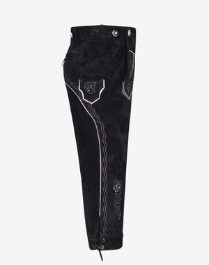 Side view of men’s black bundhosen highlighting pocket detail, contrast piping and leg embroidery