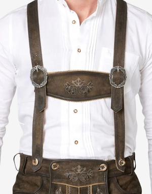 Close up of suspenders and chest panel on mens Bavarian leather shorts set with embossed detailing