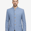 Model wearing blue wool alpine jacket front view highlighting stand collar, classic buttons and authentic Oktoberfest outfit.
