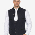 Model wearing mens blue wool Bavarian vest paired with traditional white shirt and lederhosen for Oktoberfest outfit.