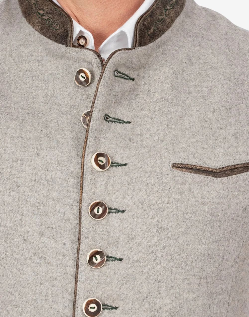 Close up of mens Trachten waistcoat showing horn buttons, textured wool fabric and traditional Bavarian tailoring.