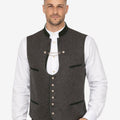 Model wearing mens elegant Trachten vest paired with traditional shirt and lederhosen for authentic Bavarian Oktoberfest outfit.