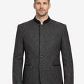 Front portrait view of model wearing gray Trachten jacket highlighting wool texture, stand collar and Bavarian tailoring.