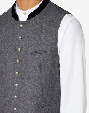 Close up of mens gray wool Trachten vest showing traditional horn buttons, textured wool fabric and Bavarian craftsmanship.