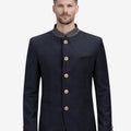 Model wearing heritage blue Oktoberfest jacket for men highlighting Bavarian style, stand collar and traditional German festival outfit.