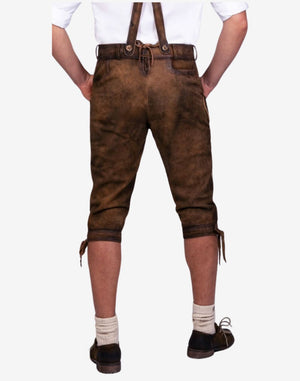 Rear view of mens heritage style bundhosen worn with suspenders showing back fit, leather texture and classic alpine traditional styling