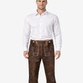 Front view of model wearing mens heritage style Bundhosen in brown leather with traditional Bavarian embroidery and knee tie details