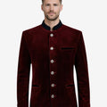 Model wearing maroon velvet Trachten jacket front view highlighting velvet texture, alpine buttons and classic Oktoberfest style.
