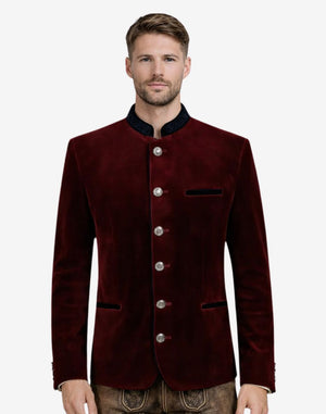 Model wearing maroon velvet Trachten jacket front view highlighting velvet texture, alpine buttons and classic Oktoberfest style.