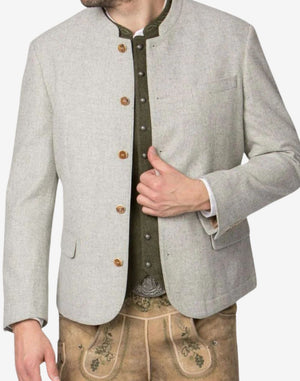 Angled view of model wearing off white wool Trachten jacket paired with lederhosen showing authentic Oktoberfest style.