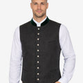 Model wearing mens Oktoberfest wool vest paired with shirt and lederhosen for traditional Bavarian festival outfit.