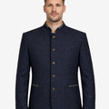 Model wearing premium blue Oktoberfest jacket front view featuring stand collar, classic buttons and traditional Bavarian style.
