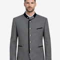 Model wearing rustic wool Trachten jacket front view highlighting traditional Bavarian buttons, black trim and classic Oktoberfest style.