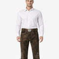 Front view of model wearing mens traditional Alpine Bundhosen in brown leather with Bavarian embroidery and classic knee tie details