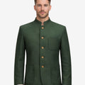 Front view of model wearing Mens Traditional Alpine Jacket in forest green with stand collar and wooden buttons