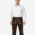Men's dark brown leather Bundhosen worn with a white shirt featuring light embroidery, adjustable suspenders, and lace-up knee openings.