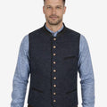 Model wearing navy blue wool Trachten vest for men paired with traditional Bavarian outfit, ideal for Oktoberfest and Alpine occasions.