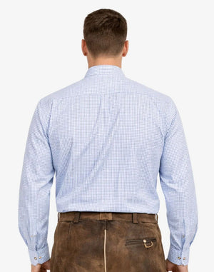 Man wearing a light blue checkered shirt and brown leather pants on a white background