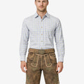 Model wearing Oktoberfest ready lederhosen for men in brown leather with traditional Bavarian embroidery and belt buckle