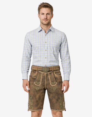 Model wearing Oktoberfest ready lederhosen for men in brown leather with traditional Bavarian embroidery and belt buckle