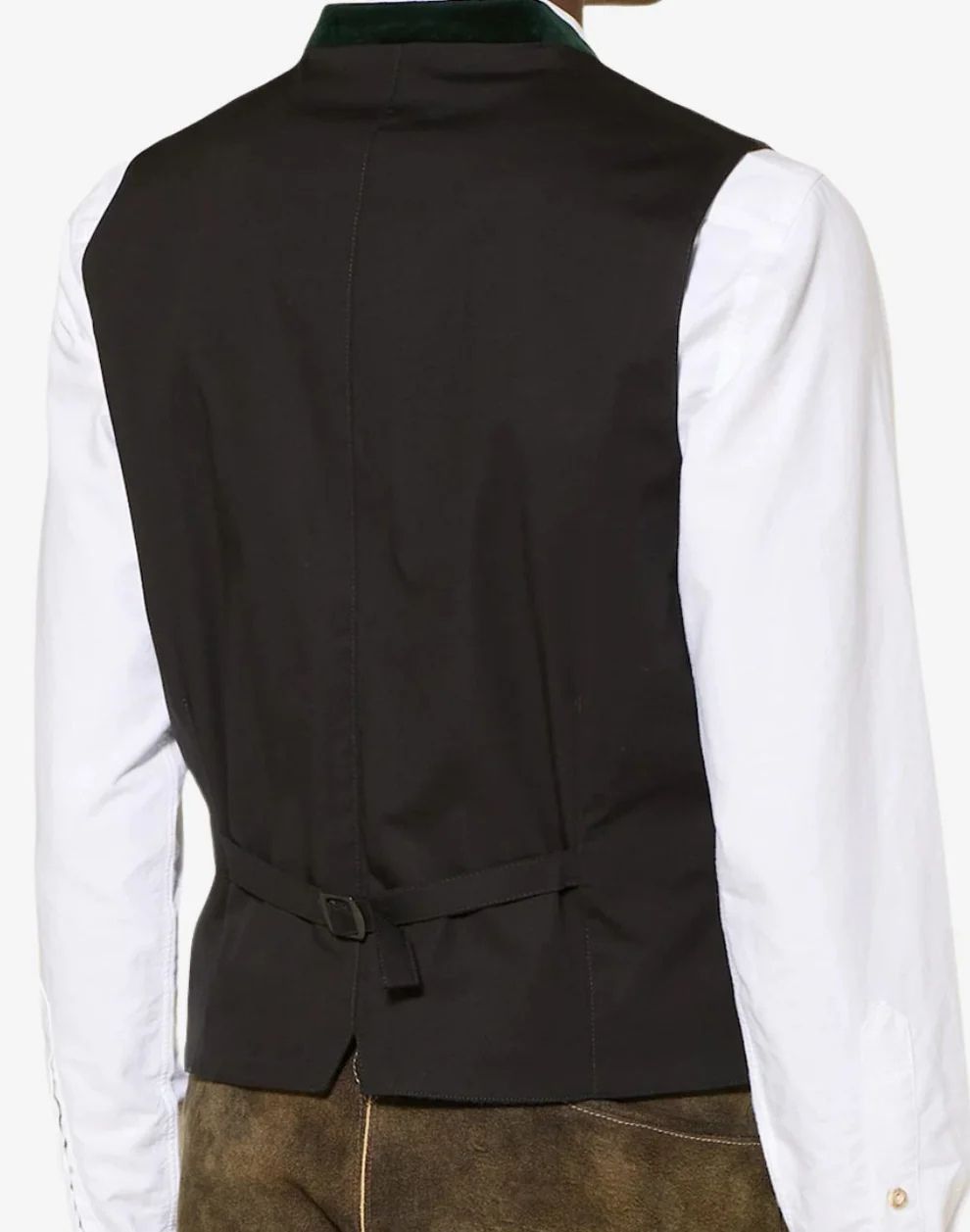 Black vest over a white shirt with a green collar, worn with brown pants.