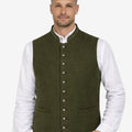 Male model wearing olive green wool Trachten vest paired with traditional lederhosen, ideal for Oktoberfest and Alpine occasions.