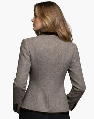 Woman wearing a gray blazer on a white background