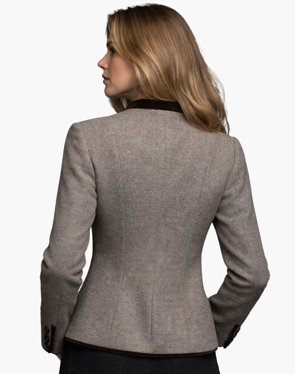 Woman wearing a gray blazer on a white background