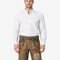 Model wearing premium Bavarian lederhosen for men in brown leather with traditional embroidery and belt buckle