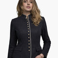 Woman wearing a premium Bavarian Trachten jacket in dark charcoal grey with contrast piping, decorative buttons, and a fitted traditional design, against a white background.