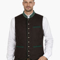 Man wearing a brown vest with green accents and a white shirt on a white background