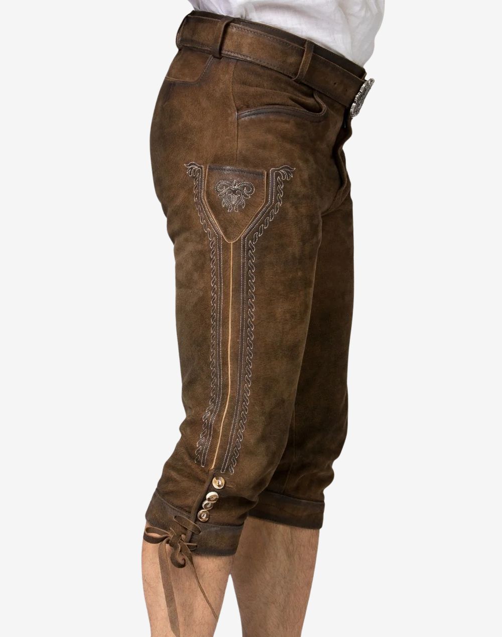 Side angle showing embroidered leg panel, decorative stitching and aged leather surface on men’s bundhosen