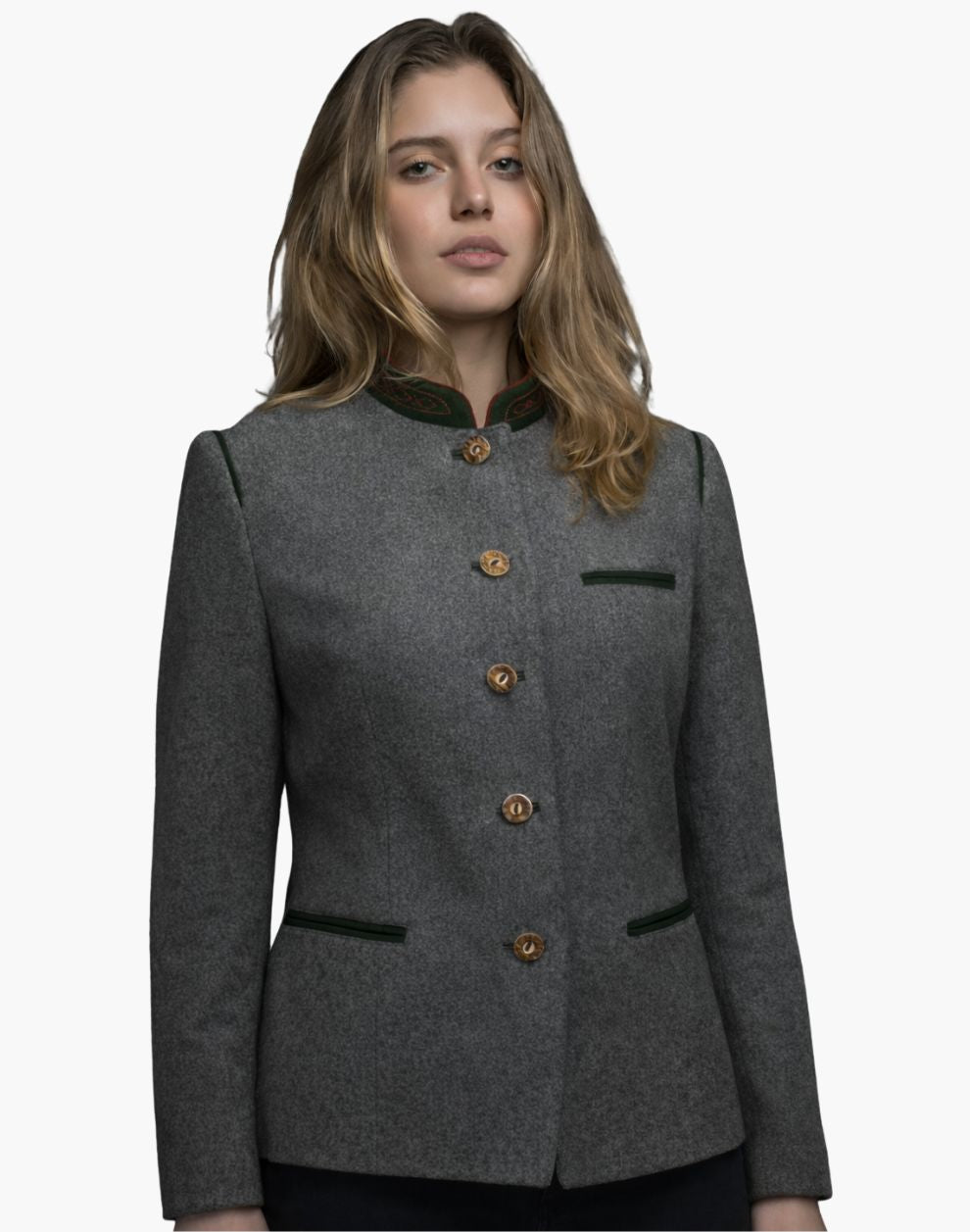 Front view of a woman wearing a charcoal gray tailored jacket with a stand-up collar trimmed in dark green. A vertical row of small metallic buttons runs down the front, and the fitted silhouette is styled with dark jeans. The background is plain light gray.