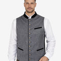 Front view of model wearing Premium Trachten Vest for Men in grey fabric with black trim pockets and metal buttons
